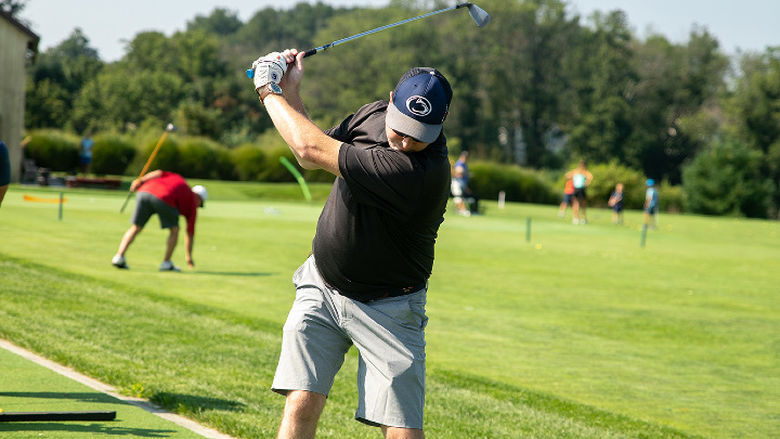 A man swings a golf club