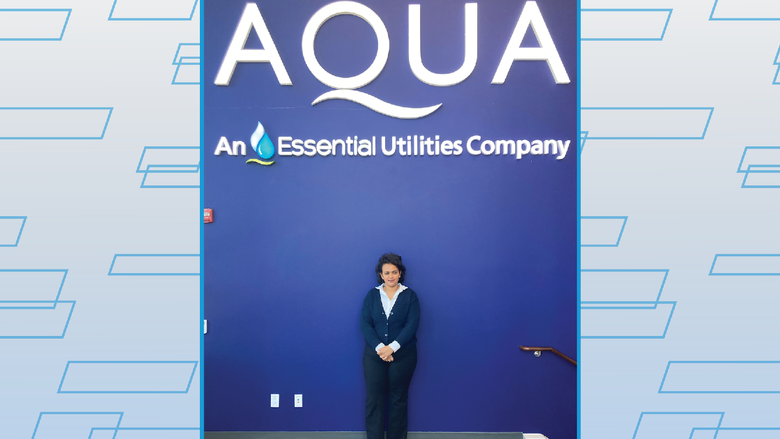 Nuhamin standing by Aqua sign 