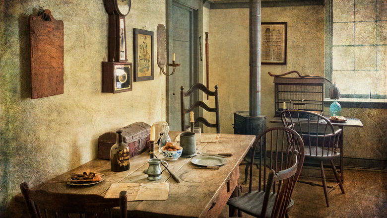 A dining room with older wooden furniture