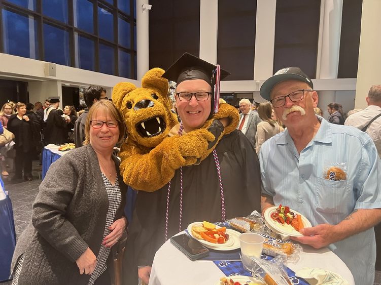Jason Herman and his parents with the Nittany Lion at Great Valley's commencement ceremony