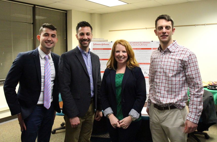 Penn State Great Valley graduate students stand in front of their audit poster