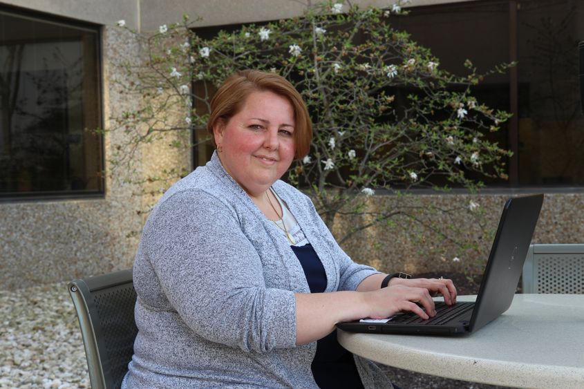 Jackie Markle seated with a laptop