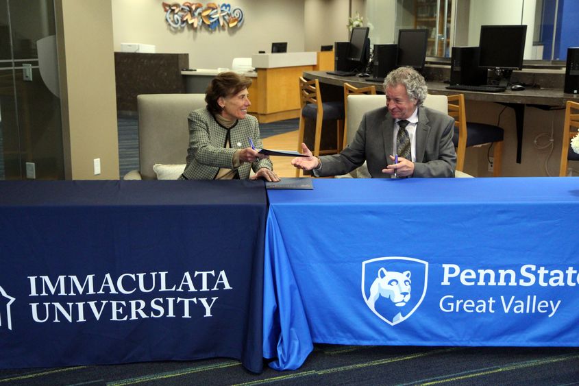 Barbara Lettiere, president of Immaculata University, signing an agreement with Penn State Great Valley Chancellor Jim Nemes at the Great Valley campus