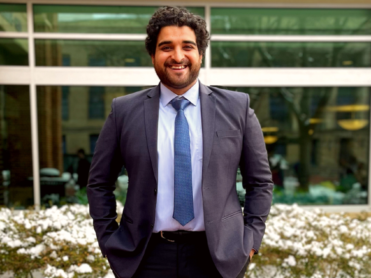 Aditya Mathkar standing in front of a building