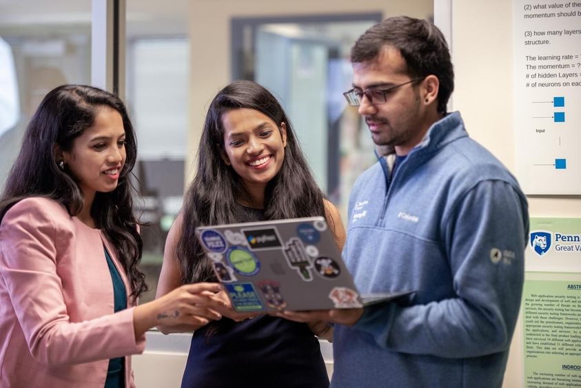 Students looking at a laptop 