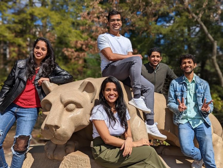 iLenz team members sitting in front of the Nittany Lion Shrine